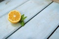 Sliced Ã¢â¬â¹Ã¢â¬â¹lemon with a leaf on a blue wooden background with empty place for text Royalty Free Stock Photo